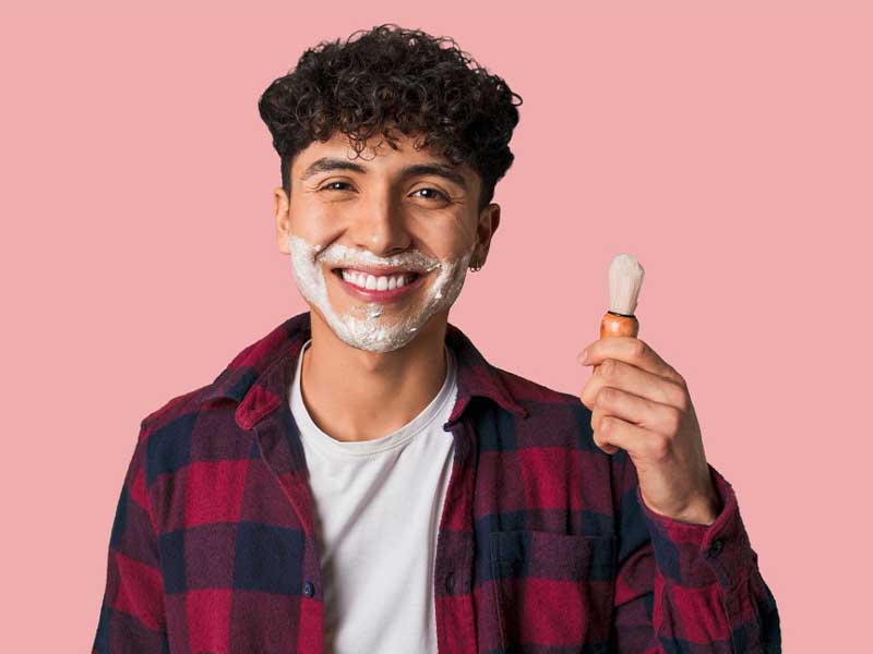 Young man Shaves with Acne